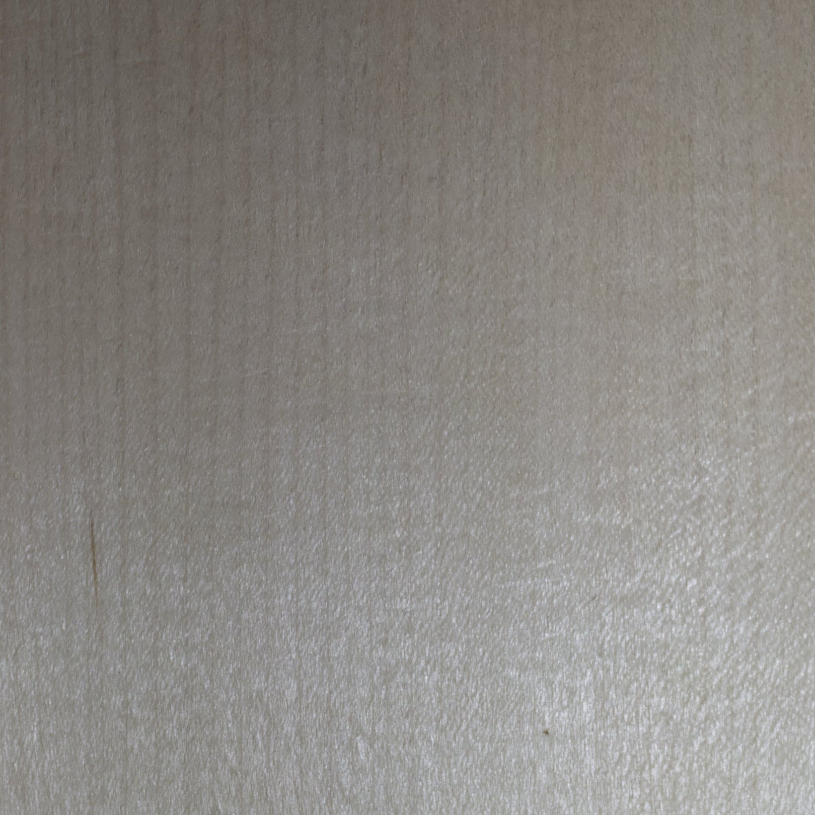 Wooden panel with a label indicating 'Maple Quarter Cut USA' on a blurred background.